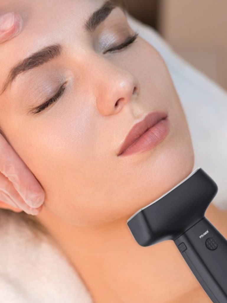 Soin esthétique du visage avec un applicateur posé sous la mâchoire.